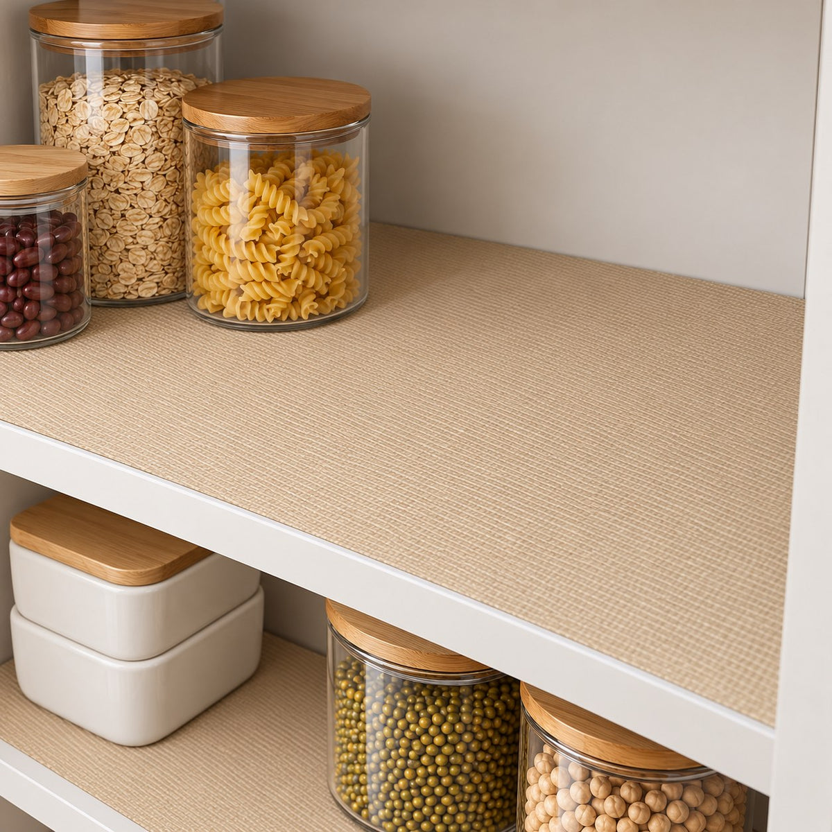Khaki shelf liner beneath closed storage jars on a pantry shelf