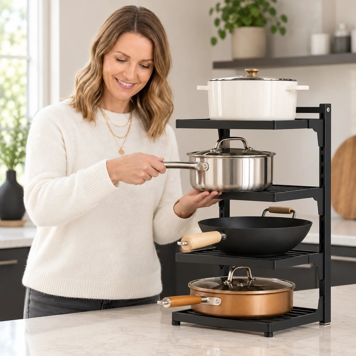Emma Carter supporting a saucepan while reaching for it on the four-tier WAFORA PanRise organizer.