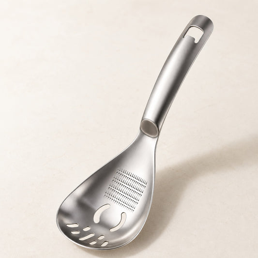 WAFORA MashMate multifunction stainless-steel kitchen spoon on a warm-white surface