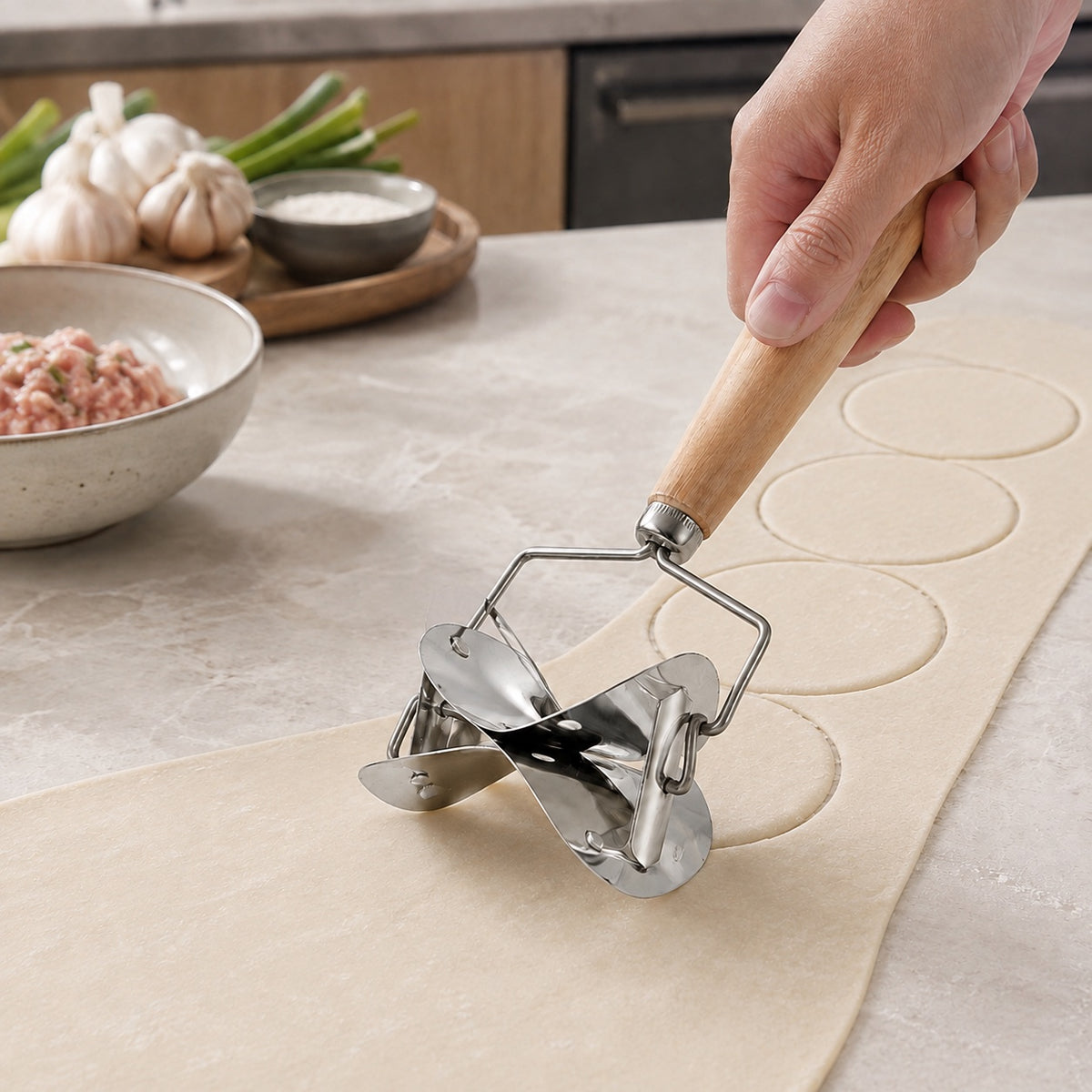 WAFORA WrapWheel rolling dumpling wrapper cutter moving across a sheet of fresh dough