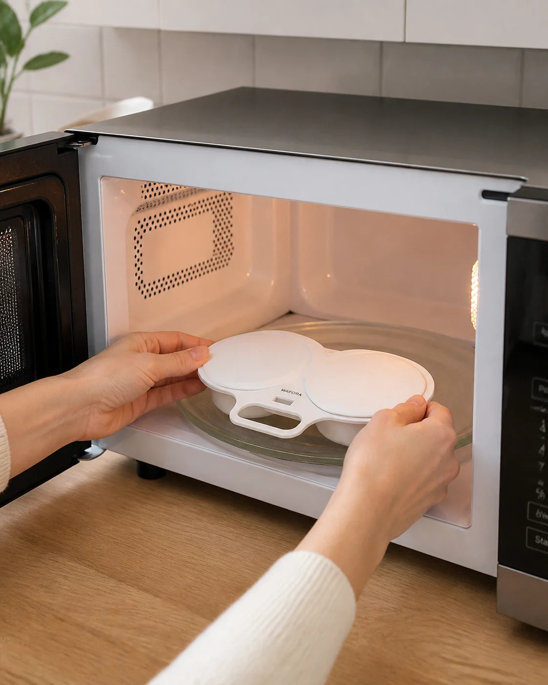 Closed WAFORA PoachLift Duo microwave egg cooker being placed on a microwave turntable