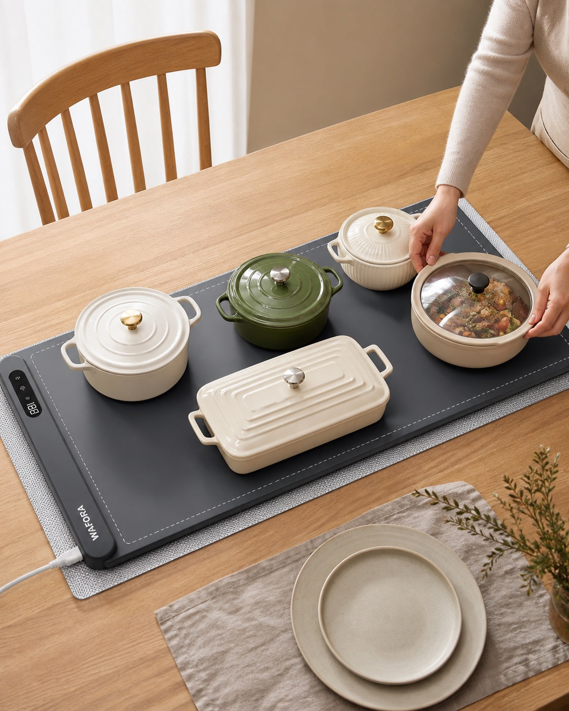 WAFORA™ TableWarm XL roll-up food warming mat with four dish pots on a dining table.