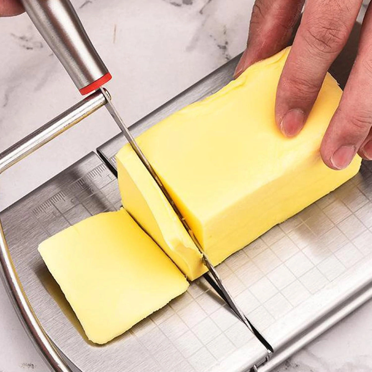 Original close-up photograph showing the real flat blade, marked board and cheese cutting mechanism