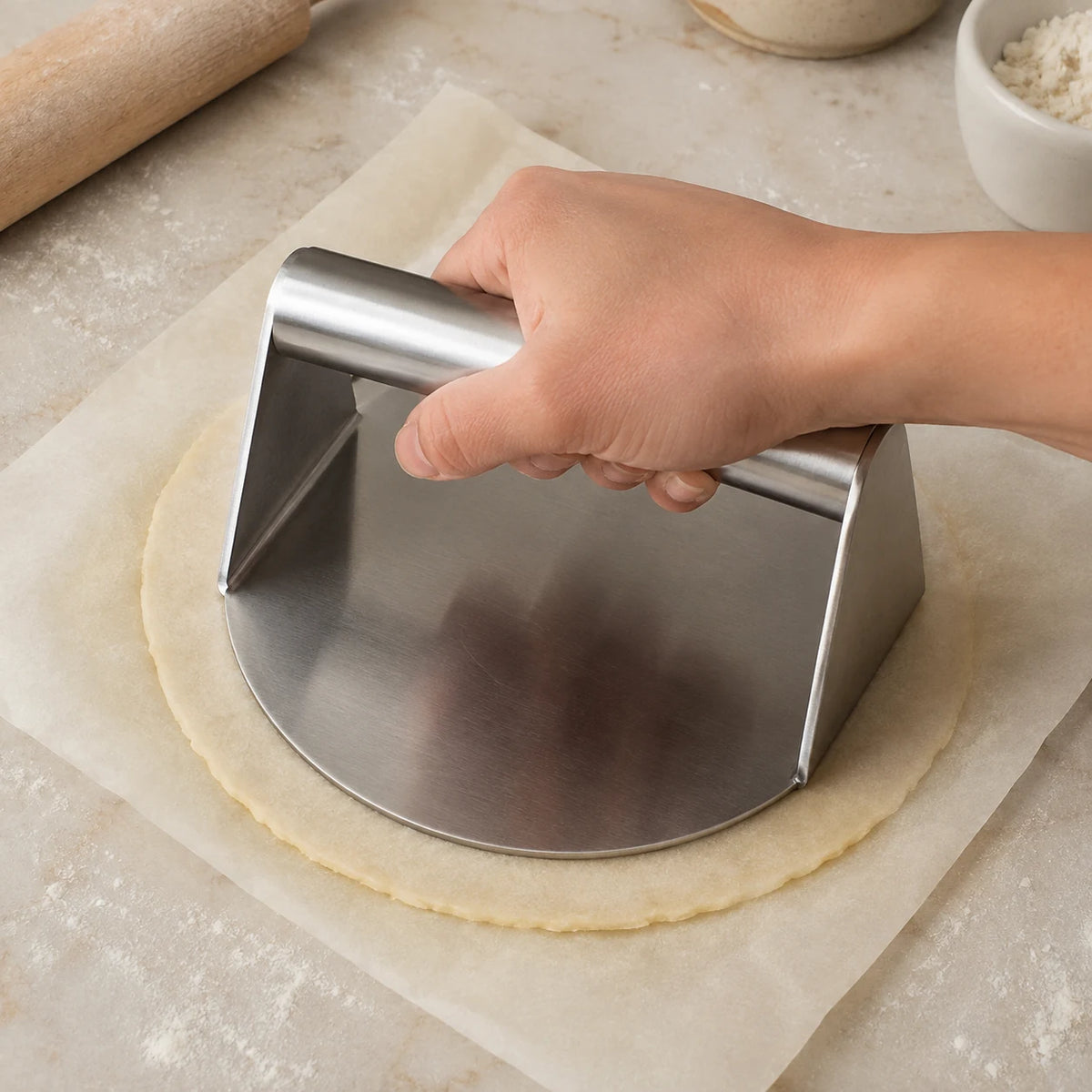 Close-up of WAFORA SmashPress flattening pastry dough between parchment