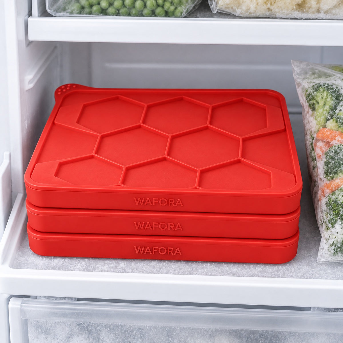Closed WAFORA BurgerBatch trays stacked neatly on a modern freezer shelf.