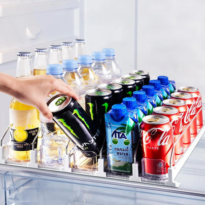 Five-row fridge drink organizer with white base, wire dividers and clear front stops holding upright cans and bottles